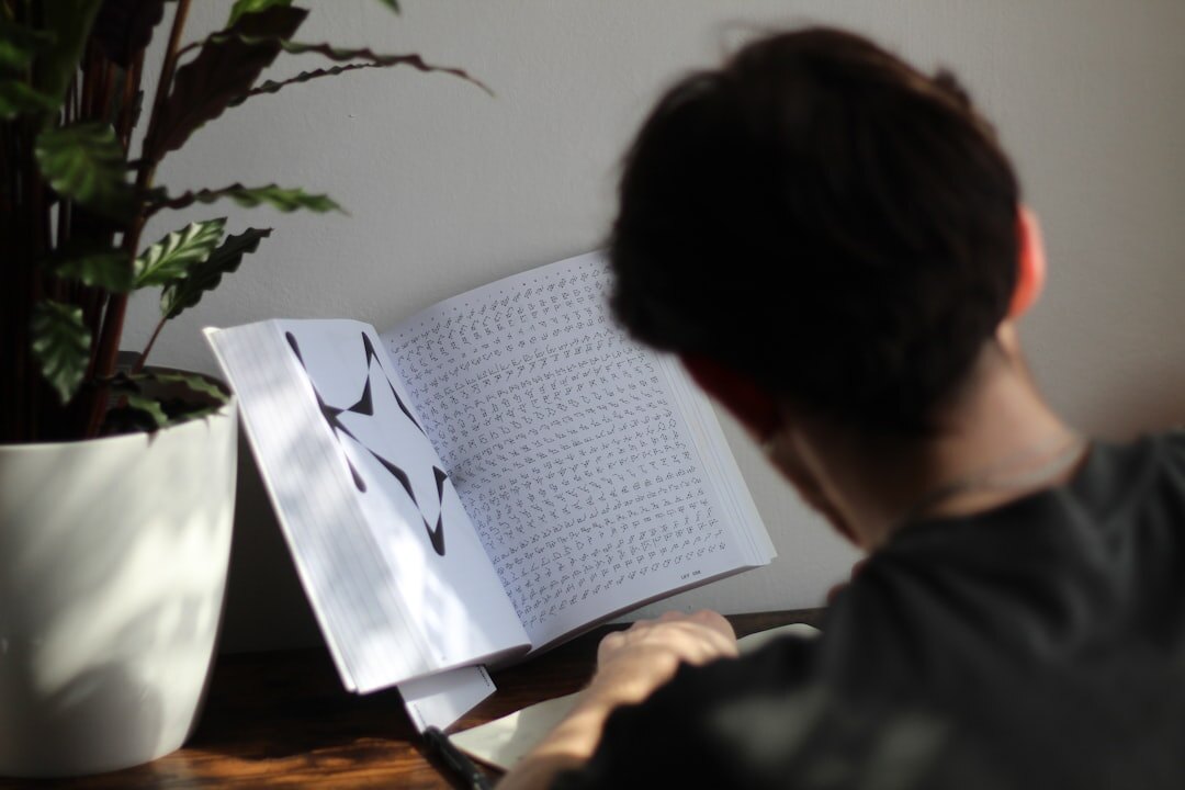 person reading book at home